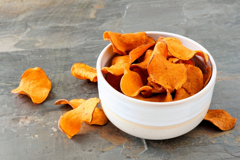 Bowl of healthy sweet potato chips over a slate background - Bettoli ...